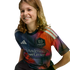 A smiling child with long, wavy light brown hair wears a colorful Houston Dynamo FC soccer jersey against a solid black background.
