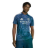 A man in a blue, geometric-patterned Adidas soccer jersey with "ETIHAD AIRWAYS" in white lettering on the front, and navy blue pants. He has dark hair and is looking directly at the camera.