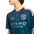 Person wearing a navy and teal New York City FC soccer jersey with a circular geometric pattern, Adidas logo, and Etihad Airways sponsor text.