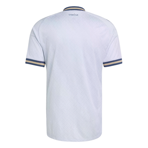 Back view of a white textured jersey with blue and gold striped trim on the collar and sleeve cuffs. Small cursive "italia" text is printed near the collar.