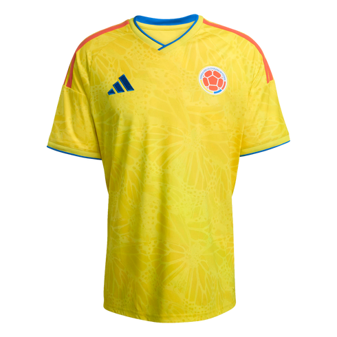 Yellow Adidas Colombia national team soccer jersey with a subtle tonal butterfly pattern, blue collar and sleeve trim, and orange shoulder stripes.