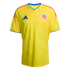 Yellow Adidas Colombia national team soccer jersey with a subtle tonal butterfly pattern, blue collar and sleeve trim, and orange shoulder stripes.