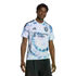 A man wearing a light blue and pink tie-dye San Jose Earthquakes soccer jersey with an El Camino Health logo.