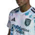 Close-up of a San Jose Earthquakes soccer jersey with a light blue and pink marbled pattern, featuring the Adidas logo, team crest, and El Camino Health sponsor logo.
