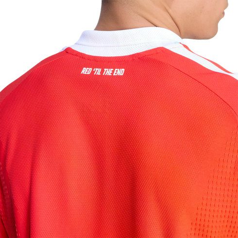 Close-up of the back of a red sports jersey with a white collar. The text "RED 'TIL THE END" is printed in white across the upper back.