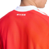Close-up of the back of a red sports jersey with a white collar. The text "RED 'TIL THE END" is printed in white across the upper back.