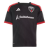 A black short-sleeved D.C. United soccer jersey featuring the team crest, white Adidas and Guidehouse logos, and red stripes on the shoulders and sleeve cuffs.