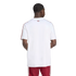 Rear view of a man wearing a white t-shirt with red shoulder stripes and red shorts against a black background.