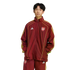 A person wearing a maroon and gold Adidas Arsenal football tracksuit, standing against a plain white background.