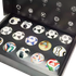 A collection of miniature Adidas FIFA World Cup soccer balls showcased in a large black presentation box, featuring iconic match ball designs from various years.
