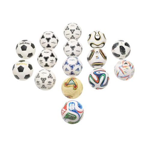 Collection of various Adidas FIFA World Cup soccer balls from different years arranged in a symmetrical pattern on a black background.