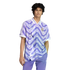 A young man with dark curly hair wearing a purple and white geometric Real Madrid jersey and matching pants against a solid black background.