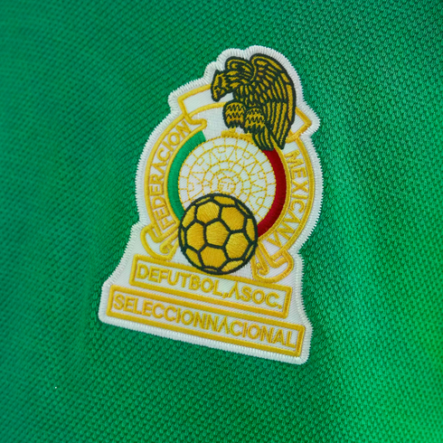 Embroidered crest of the Mexican national football team on a green jersey.
