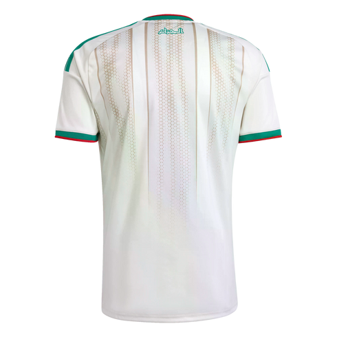 Back view of a white Algeria football jersey with green and red trim. It features vertical beige patterned stripes and green Arabic text below the neck.