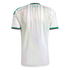 Back view of a white Algeria football jersey with green and red trim. It features vertical beige patterned stripes and green Arabic text below the neck.