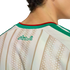 Back view of a person wearing an Algerian national football team jersey with "Algeria" in Arabic script, white and gold stripes, and a green and red collar.
