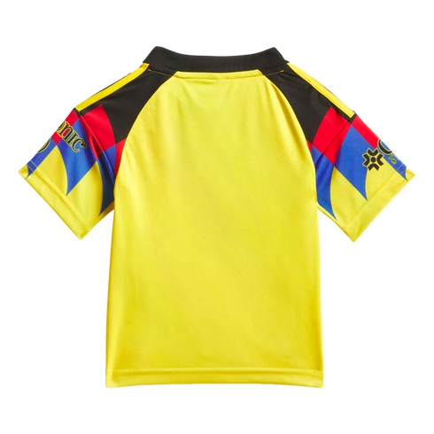Back view of a bright yellow short-sleeved jersey with black shoulders and vibrant red, blue, and yellow geometric patterns on the sleeves.