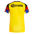 Back view of a yellow sports jersey with a black 'Corona' logo across the shoulders and colorful, multi-colored patterned sleeves.