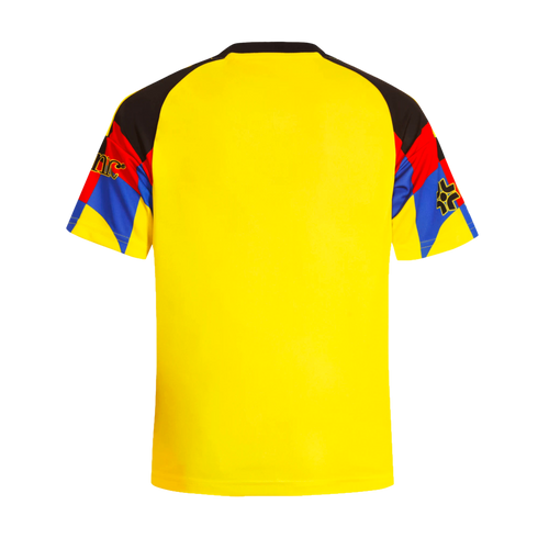 The back of a bright yellow sports jersey featuring multi-colored raglan sleeves with black, red, and blue geometric patterns.