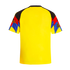 The back of a bright yellow sports jersey featuring multi-colored raglan sleeves with black, red, and blue geometric patterns.