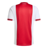 Back of an Ajax home jersey featuring a wide red vertical stripe with a diamond texture, white sleeves, and red/black striped trim on the collar and cuffs.