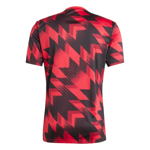 Back of a short-sleeved jersey featuring a bold, red and black geometric zig-zag pattern with a distressed effect.