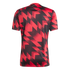 Back of a short-sleeved jersey featuring a bold, red and black geometric zig-zag pattern with a distressed effect.