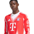 A young Black man wearing a red and white long-sleeved FC Bayern Munich soccer jersey with visible Adidas and T-Mobile logos against a white background.