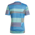 The back of a short-sleeved athletic jersey with a complex geometric pattern of blue, teal, lime green, and grey stripes arranged in horizontal and curved blocks.