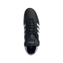 Top-down view of a black leather Adidas Copa Mundial soccer cleat featuring signature white stripes and a folded tongue, set against a black background.