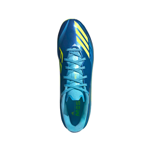Top-down view of a blue Adidas Messi F50 soccer cleat with yellow accents against a black background.