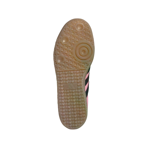 Bottom of an Adidas sneaker with a translucent gum rubber sole, showing a textured tread pattern with circular pivot points.