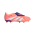 A coral-colored Adidas Predator football boot with a blue fold-over tongue, white diagonal stripes, and firm ground studs on the sole.