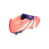 Peach and purple Adidas Predator soccer cleat with white diagonal stripes, isolated on a black background.