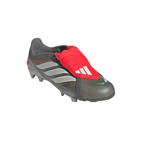 Dark grey Adidas Predator soccer cleat with silver stripes and a bright red fold-over tongue secured by a strap, isolated on a black background.