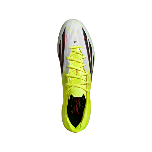 Top-down view of a white and neon yellow Adidas soccer cleat with lime green laces and black details on a black background.
