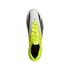 Top-down view of a white and neon yellow Adidas soccer cleat with lime green laces and black details on a black background.
