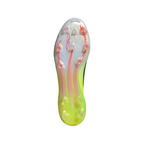 The soleplate of a white and lime green soccer cleat featuring translucent material, red "F50" branding, and orange-accented studs.