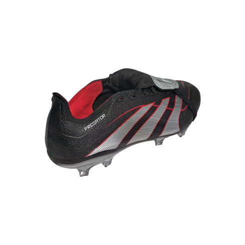 A black Adidas Predator soccer cleat with silver stripes and red accents, featuring a fold-over tongue and textured upper, against a solid black background.