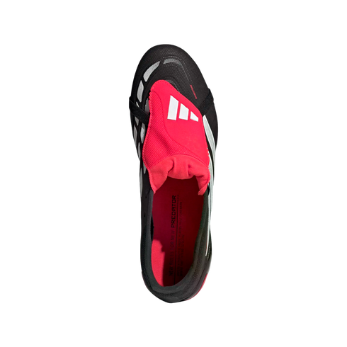 Top-down view of a black Adidas Predator soccer cleat featuring a vibrant pink fold-over tongue and interior.