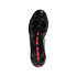 Bottom view of a glossy black Adidas soccer boot featuring pink arrow-shaped studs and a midfoot strap on a black background.