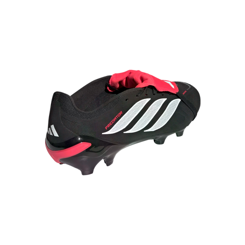 Black Adidas Predator soccer cleat with a red fold-over tongue, white triple stripes, and red accents on a black background.