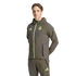 Man in an olive green Real Madrid Adidas tracksuit with neon yellow accents, standing against a black background.