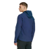 A man is shown from the back and side, wearing a navy blue hooded athletic jacket and black shorts against a solid black background.