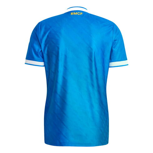Back view of a bright blue soccer jersey with yellow "RMCF" text on the neckline and white trim on the sleeves, against a black background.