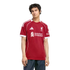 A young man modeling a red Liverpool FC jersey with white trim and sponsor logos, set against a solid black background.
