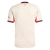 Back of a cream Liverpool FC away jersey with red and black trim. It features the red Hillsborough memorial logo below the collar and a sponsor logo on the left sleeve.