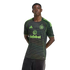 A young man models a black Celtic FC jersey featuring thin neon green horizontal stripes and logos, posed against a solid black background.