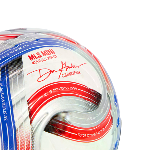 A close-up of a red, white, and blue MLS mini replica soccer ball with Commissioner Don Garber's signature and geographical coordinates.