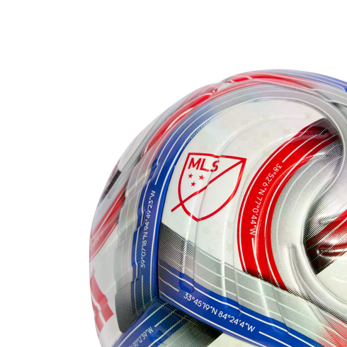 Close-up of an official MLS soccer ball featuring the league crest, red and blue stripes, and geographical coordinates printed along the patterned panels.
